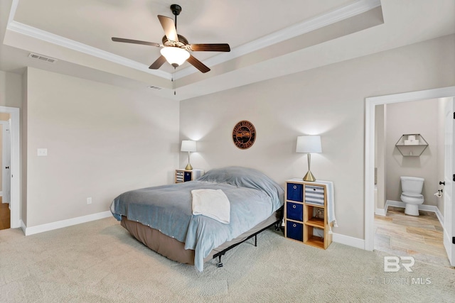 bedroom featuring carpet, a raised ceiling, visible vents, and baseboards