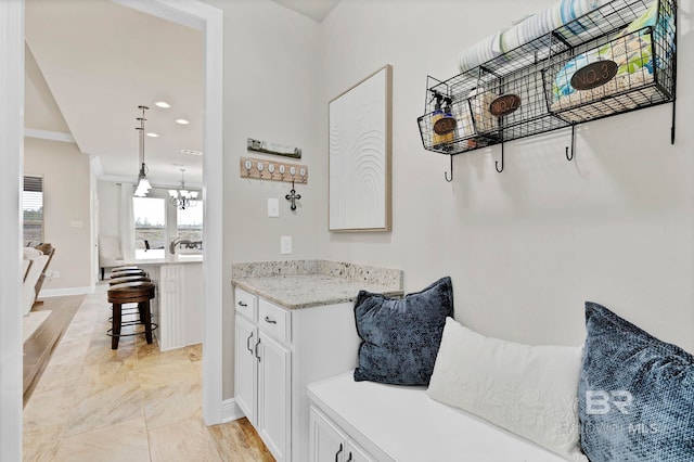 mudroom featuring recessed lighting, baseboards, and an inviting chandelier