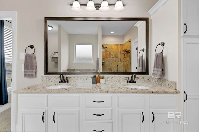 full bath with double vanity, a stall shower, and a sink