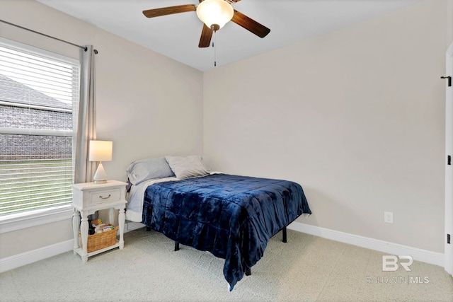 bedroom with carpet floors, ceiling fan, multiple windows, and baseboards