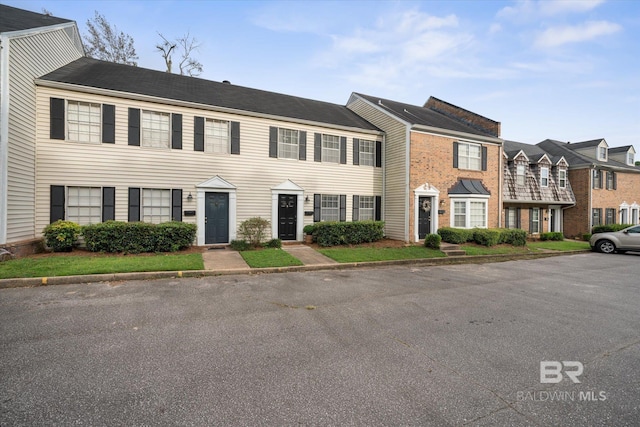 view of front of property featuring brick siding and a residential view