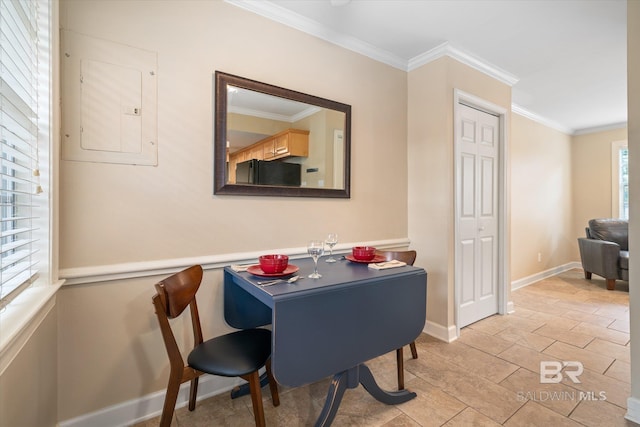 dining room featuring electric panel, baseboards, and crown molding