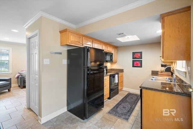 kitchen featuring ornamental molding, a sink, black appliances, dark stone counters, and baseboards