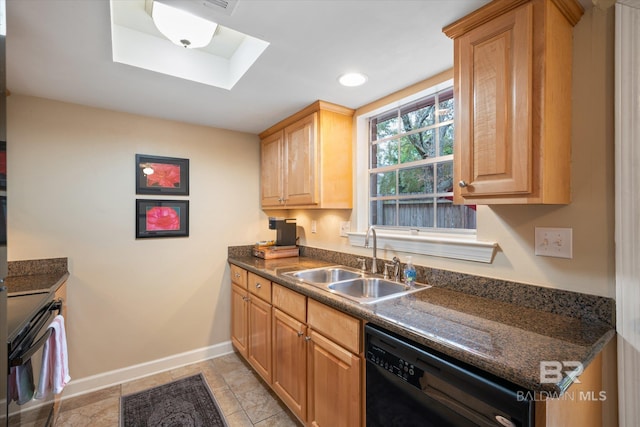 kitchen with a skylight, a sink, baseboards, dishwasher, and dark countertops