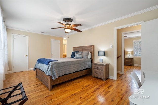 bedroom featuring light wood-style floors, visible vents, and ornamental molding