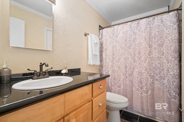 bathroom with a textured wall, vanity, toilet, and crown molding