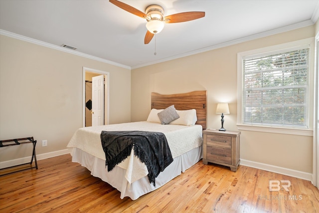 bedroom with light wood finished floors, visible vents, ornamental molding, ceiling fan, and baseboards