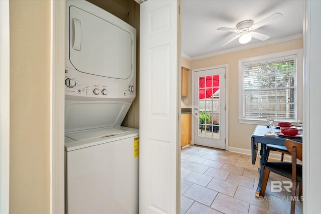 washroom featuring ornamental molding, stacked washer and clothes dryer, plenty of natural light, and laundry area