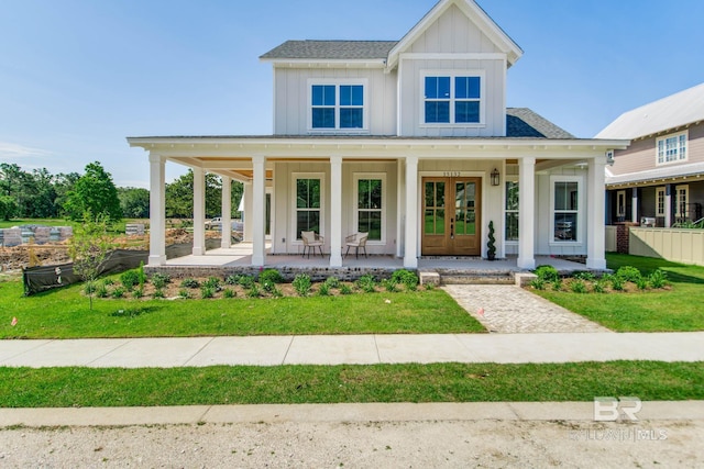 15132 Itea Dr, Foley, AL 36535 - view of front of home featuring board and batten siding, a porch, a front lawn, and french doors