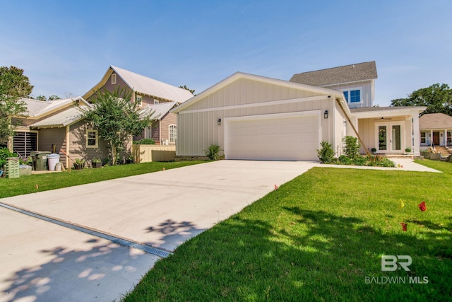 15132 Itea Dr, Foley, AL 36535 - view of front of property with french doors, board and batten siding, a garage, a front yard, and concrete driveway