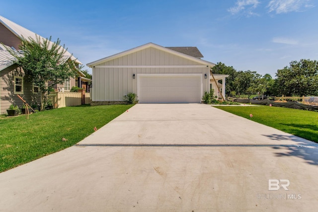 15132 Itea Dr, Foley, AL 36535 - view of front facade featuring board and batten siding, a front yard, concrete driveway, and an attached garage