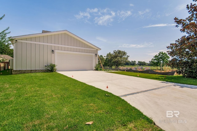 15132 Itea Dr, Foley, AL 36535 - view of front of home featuring board and batten siding, a front yard, and driveway