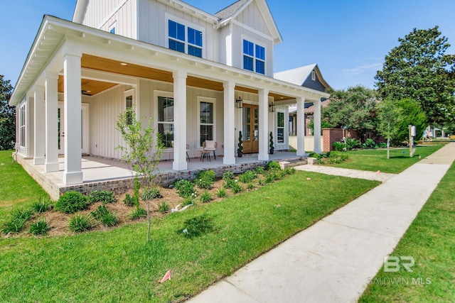 15132 Itea Dr, Foley, AL 36535 - modern inspired farmhouse with board and batten siding, french doors, a front yard, a ceiling fan, and a porch