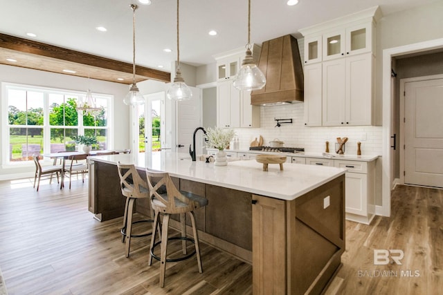 15132 Itea Dr, Foley, AL 36535 - kitchen featuring custom exhaust hood, tasteful backsplash, light wood-type flooring, a large island, and recessed lighting
