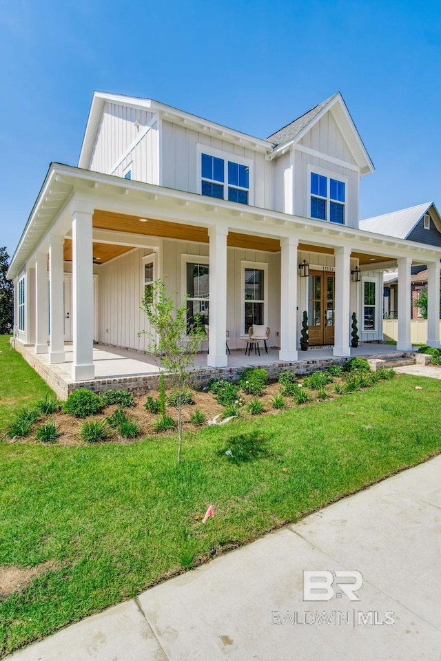 15132 Itea Dr, Foley, AL 36535 - modern farmhouse style home featuring board and batten siding, covered porch, and a front lawn