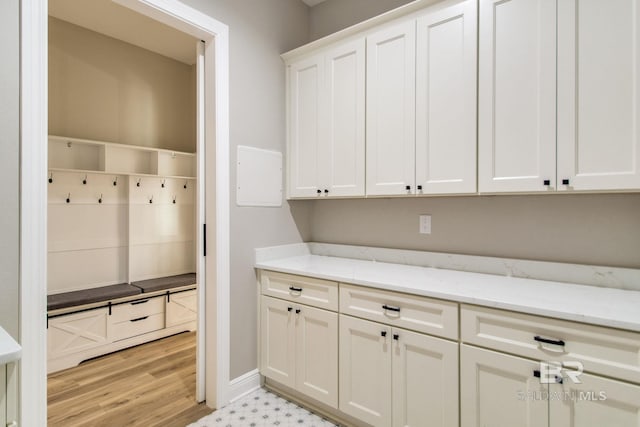 15132 Itea Dr, Foley, AL 36535 - kitchen featuring white cabinetry, light stone countertops, and light wood finished floors