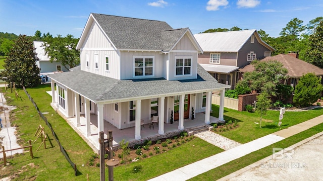 15132 Itea Dr, Foley, AL 36535 - view of front of house with roof with shingles, board and batten siding, a porch, and a front yard