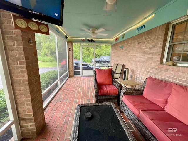 unfurnished sunroom with ceiling fan