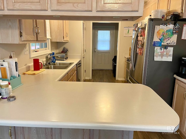 kitchen with hardwood / wood-style floors, sink, stainless steel appliances, and light brown cabinets