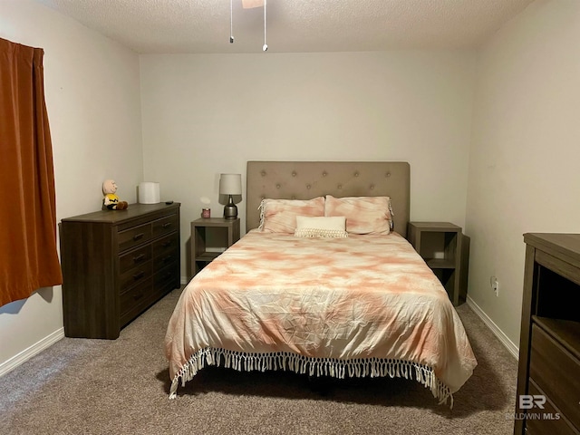 bedroom with a textured ceiling and light colored carpet