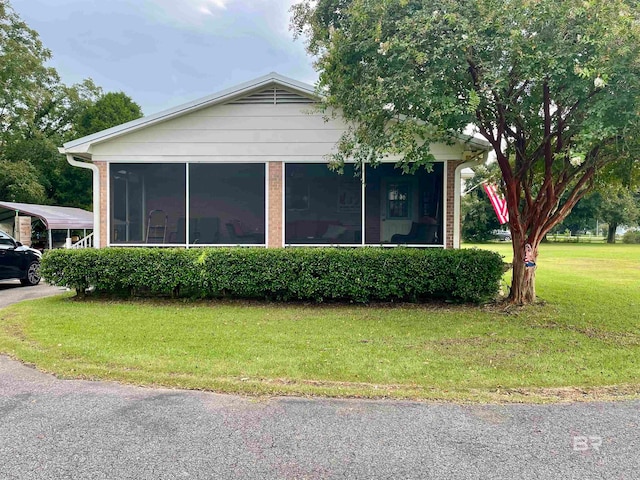 view of front of house featuring a front yard and a sunroom