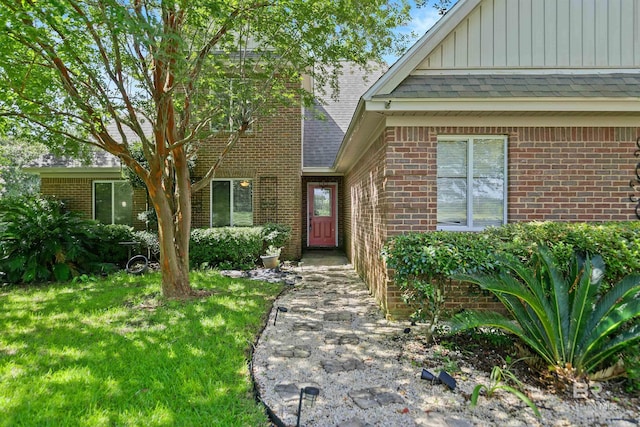 entrance to property with a lawn