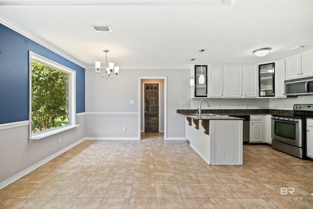 kitchen featuring kitchen peninsula, decorative backsplash, stainless steel appliances, decorative light fixtures, and white cabinets