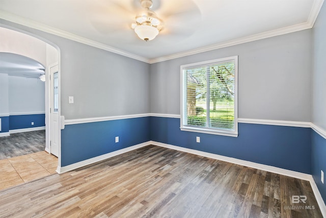 spare room featuring ceiling fan, crown molding, and wood-type flooring