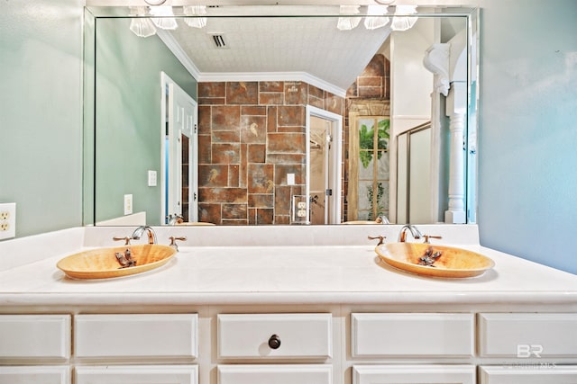 bathroom with vanity, a shower with door, and ornamental molding