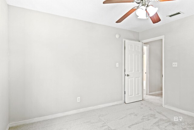 spare room with light colored carpet and ceiling fan