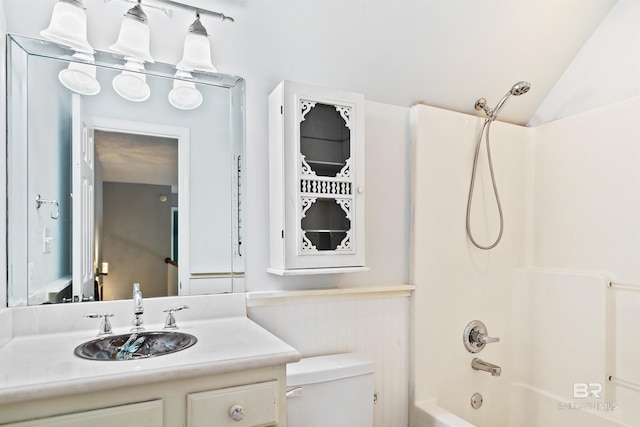 full bathroom with shower / bathtub combination, vanity, vaulted ceiling, and toilet