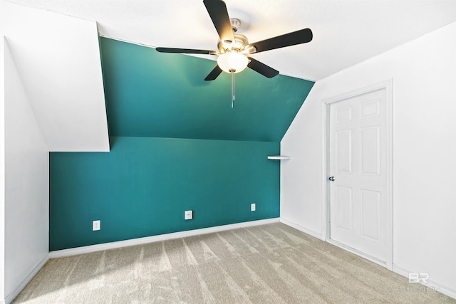 additional living space featuring light colored carpet, vaulted ceiling, and ceiling fan