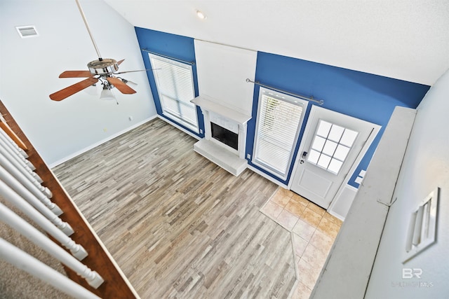 unfurnished living room featuring ceiling fan and light hardwood / wood-style flooring