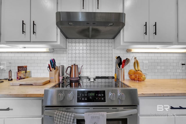 kitchen featuring white cabinets, tasteful backsplash, stainless steel range oven, and range hood