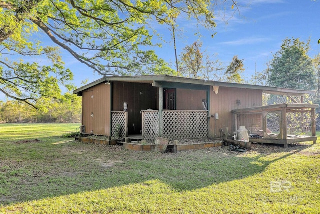 rear view of property with a lawn