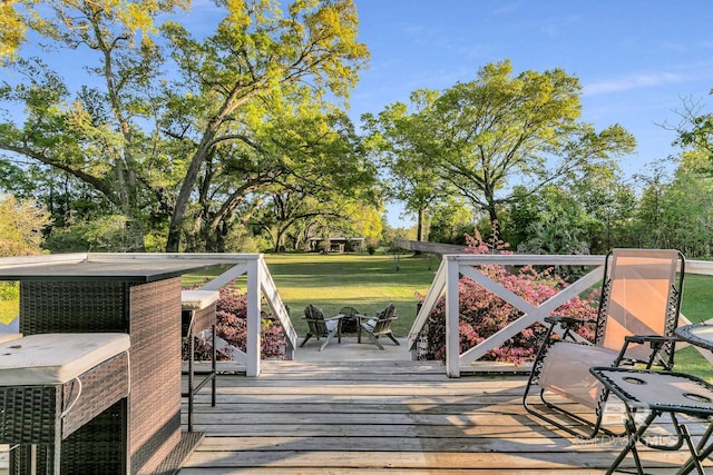 wooden terrace featuring a lawn