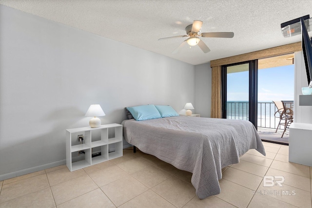 bedroom with light tile patterned floors, baseboards, a ceiling fan, access to outside, and a textured ceiling