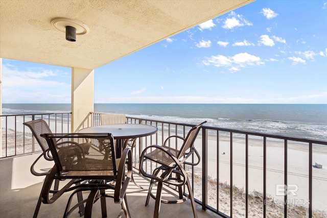 balcony with a water view and a beach view