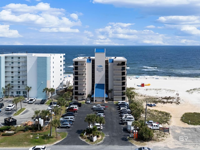 birds eye view of property featuring a water view and a view of the beach