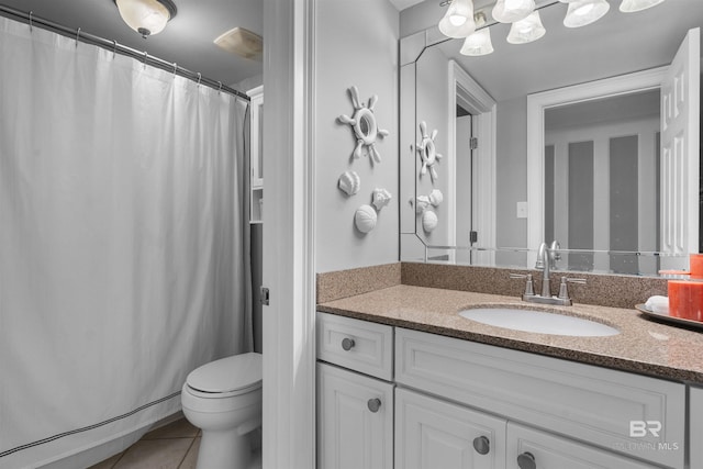 bathroom with vanity, tile patterned floors, and toilet