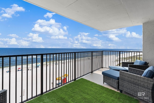 balcony featuring a view of the beach and a water view