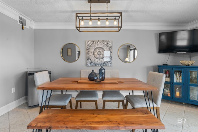 tiled dining space with crown molding and a textured ceiling