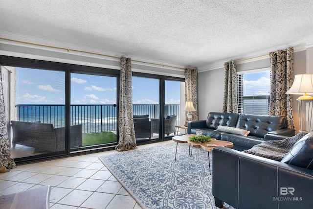 living room with a water view, ornamental molding, tile patterned flooring, and a textured ceiling