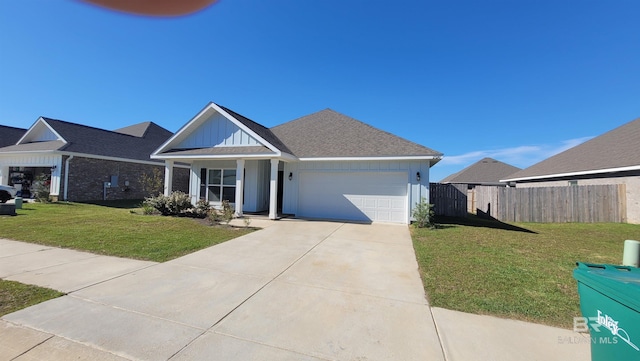 view of front of home with a garage, covered porch, and a front lawn