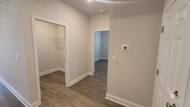 hallway with dark wood-type flooring