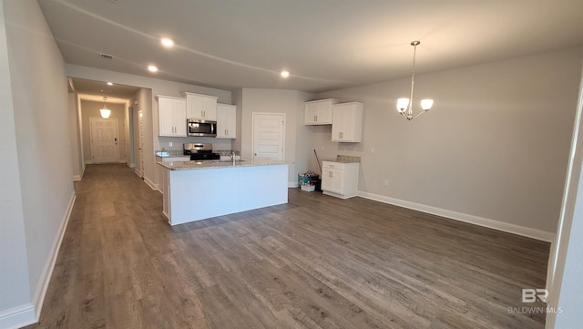 kitchen with white cabinetry, a chandelier, stainless steel appliances, light stone countertops, and a kitchen island with sink