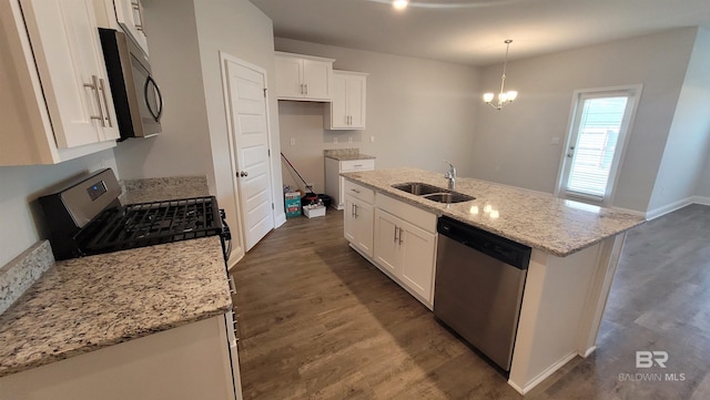 kitchen featuring white cabinetry, sink, stainless steel appliances, and a center island with sink