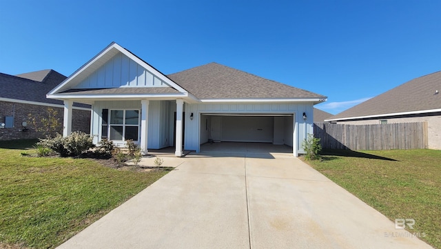 view of front of property with a porch, a garage, and a front lawn