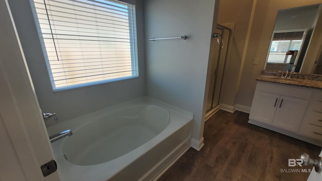 bathroom with vanity, hardwood / wood-style flooring, and shower with separate bathtub