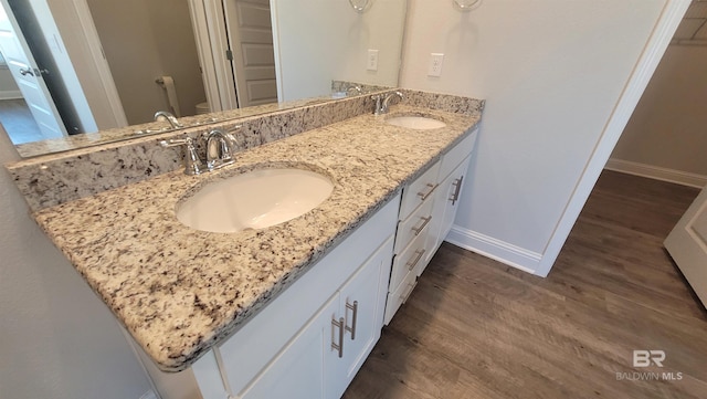 bathroom with vanity, toilet, and wood-type flooring